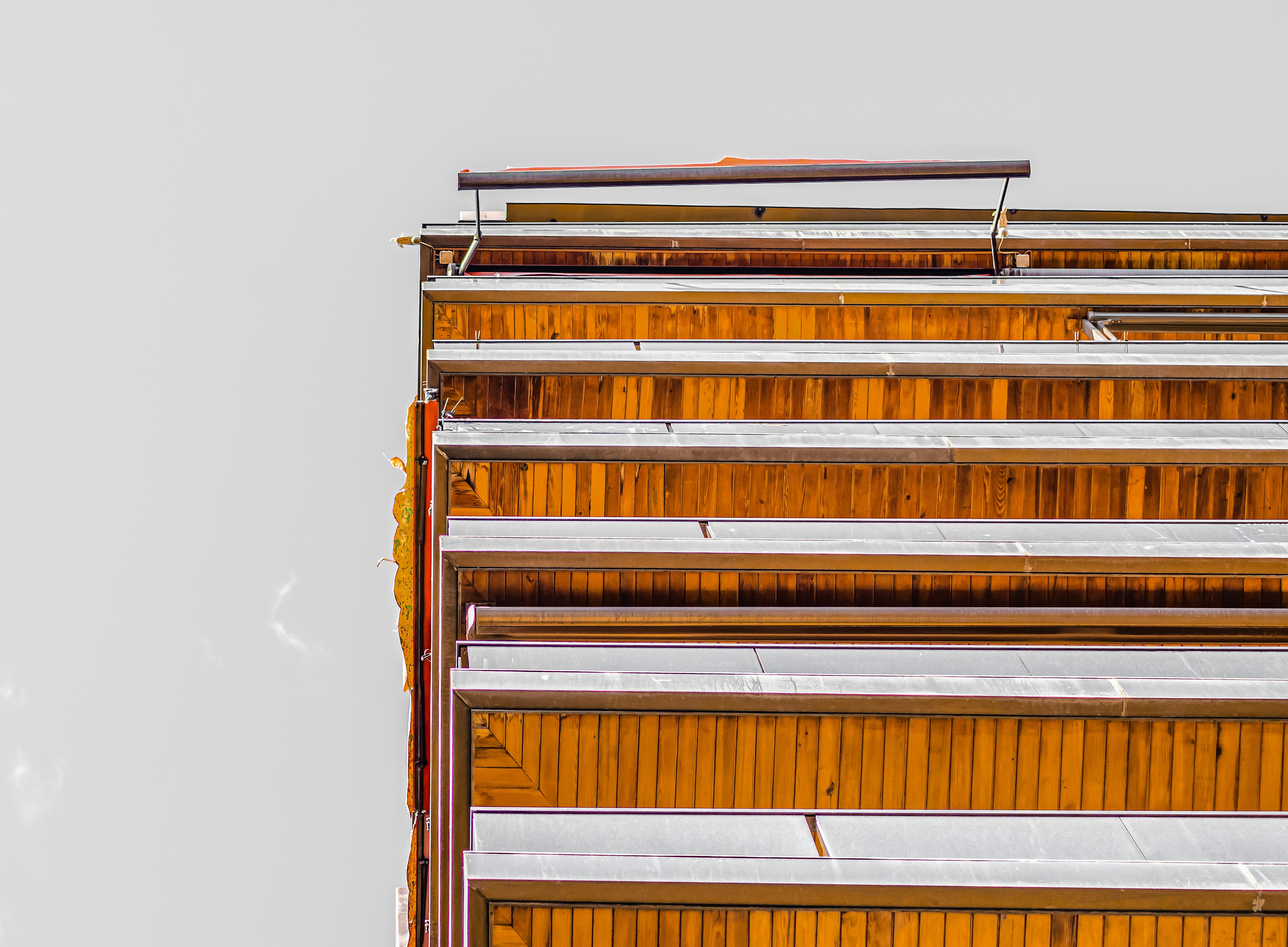 brown wooden ladder on white wall